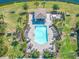 Aerial shot of the community pool area with lounge chairs, cabana, and lush landscaping at 17810 Gawthrop Dr # 406, Bradenton, FL 34211