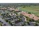 Aerial view of community clubhouse with pool, tennis courts, golf course, and parking lot at 17810 Gawthrop Dr # 406, Bradenton, FL 34211