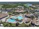 Aerial view of pool and amenity center with lounge chairs and manicured landscaping at 17810 Gawthrop Dr # 406, Bradenton, FL 34211