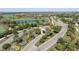 Aerial view of community entrance with lush landscaping, water feature, and guard house at 17810 Gawthrop Dr # 406, Bradenton, FL 34211