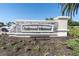 Community sign with stone base, metal lettering, and colorful landscaping at 17810 Gawthrop Dr # 406, Bradenton, FL 34211