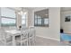 Bright dining area offers natural light, with table, white chairs and backyard views at 17810 Gawthrop Dr # 406, Bradenton, FL 34211