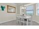 Eat-in dining area has views, modern table, with four white chairs for casual gatherings at 17810 Gawthrop Dr # 406, Bradenton, FL 34211