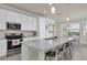 Bright, modern kitchen features white cabinets, stainless steel appliances, and an island with bar seating at 17810 Gawthrop Dr # 406, Bradenton, FL 34211