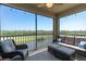 Screened-in lanai provides stunning golf course views with a ceiling fan and comfortable seating at 17810 Gawthrop Dr # 406, Bradenton, FL 34211