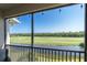 Enjoy golf course views from the screened-in lanai with black metal railing at 17810 Gawthrop Dr # 406, Bradenton, FL 34211