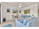 Cozy living room with blue couches and golf course themed decor at 17810 Gawthrop Dr # 406, Bradenton, FL 34211