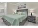 Bedroom featuring a king bed, with two side tables and large painting for added comfort at 17810 Gawthrop Dr # 406, Bradenton, FL 34211