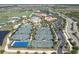 Aerial view of tennis courts, swimming pool, clubhouse, and parking lot at 17810 Gawthrop Dr # 406, Bradenton, FL 34211