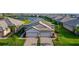 An aerial view of a home with lake views and an attractive landscaped yard at 17827 Cherished Loop, Lakewood Ranch, FL 34211