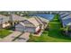 Aerial view of a neighborhood showing manicured lawns, lake views, and elegant home design at 17827 Cherished Loop, Lakewood Ranch, FL 34211