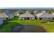 Aerial view of a home with a lush backyard that overlooks a serene pond at 17827 Cherished Loop, Lakewood Ranch, FL 34211