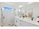 Elegant bathroom featuring marble accents, double vanity, and a glass-enclosed shower at 17827 Cherished Loop, Lakewood Ranch, FL 34211