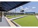 Image shows covered bocce ball courts next to the tennis court under sunny skies at 17827 Cherished Loop, Lakewood Ranch, FL 34211
