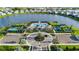 Aerial view of the community pool, tennis courts, and clubhouse in a desirable neighborhood with lush landscaping at 17827 Cherished Loop, Lakewood Ranch, FL 34211