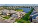 Exterior elevation of a white home with a two-car garage, lush lawn, and manicured landscaping at 17827 Cherished Loop, Lakewood Ranch, FL 34211