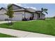 Home's exterior with a manicured lawn, landscaping, and a two-car garage at 17827 Cherished Loop, Lakewood Ranch, FL 34211