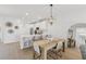 Bright kitchen with stainless appliances, island seating, and modern pendant lighting above dining area at 17827 Cherished Loop, Lakewood Ranch, FL 34211
