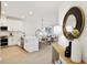 Modern kitchen with white cabinetry, stainless steel appliances, and an island with seating at 17827 Cherished Loop, Lakewood Ranch, FL 34211