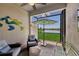 Cozy screened-in lanai with comfortable seating, an umbrella table, and views of the water at 17827 Cherished Loop, Lakewood Ranch, FL 34211