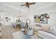 Spacious living area with modern décor, neutral color palette, and seamless flow to the open kitchen at 17827 Cherished Loop, Lakewood Ranch, FL 34211