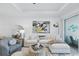 Bright living room features stylish decor, white sectional sofa, and access to outdoor living space at 17827 Cherished Loop, Lakewood Ranch, FL 34211
