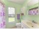 Bright bathroom with a shower and window with a view, complemented by a vanity and storage at 1809 67Th W St, Bradenton, FL 34209