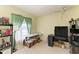 Bedroom or office with a window, shelving units, and a work table; the room is cluttered with moving boxes at 1809 67Th W St, Bradenton, FL 34209