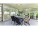 Sun-filled enclosed patio with a ceiling fan, garden view, and a dining table with chairs at 1809 67Th W St, Bradenton, FL 34209