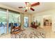 Inviting enclosed patio showcasing a ceiling fan, decorative plants, and seamless access to indoor spaces at 1809 67Th W St, Bradenton, FL 34209