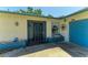 The property's enclosed entrance features a wrought iron gate and stylish door, offering security and curb appeal at 1809 67Th W St, Bradenton, FL 34209