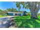 Charming single-story house with beautiful lawn and mature tree offering shade; attached garage adds convenience and appeal at 1809 67Th W St, Bradenton, FL 34209