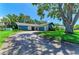 Inviting single-story home featuring an attached garage and lush landscaping, showcasing great curb appeal on a sunny day at 1809 67Th W St, Bradenton, FL 34209