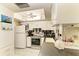 Well-lit kitchen offering white cabinets, stainless appliances, a patterned backsplash, and ample counter space at 1809 67Th W St, Bradenton, FL 34209