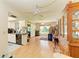 Open-concept living room with wood floors connects kitchen and dining area; the room is cluttered with moving boxes at 1809 67Th W St, Bradenton, FL 34209