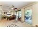 Comfortable living room featuring a ceiling fan, entertainment center, and glass doors leading to an enclosed patio at 1809 67Th W St, Bradenton, FL 34209