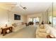 Cozy living room with comfortable seating, ceiling fan, and sliding glass doors to lanai for indoor-outdoor living at 1809 67Th W St, Bradenton, FL 34209