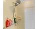 Shower with white tiles, shampoo bottles and handheld shower head at 1809 67Th W St, Bradenton, FL 34209