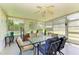 Bright sunroom with large windows, ceiling fan, and comfortable seating, perfect for relaxing and enjoying the view at 1809 67Th W St, Bradenton, FL 34209