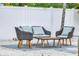 Inviting backyard seating area with comfortable wicker chairs and a table, ideal for outdoor entertaining at 1921 Fern Ave, Sarasota, FL 34235