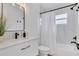 Stylish bathroom featuring a tub with shower and modern vanity at 1921 Fern Ave, Sarasota, FL 34235
