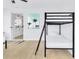 Bright bedroom featuring bunkbeds, a comfortable queen bed, and an en suite bathroom entrance for added convenience at 1921 Fern Ave, Sarasota, FL 34235