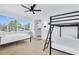Shared bedroom with bunkbeds, light wood floors, and lots of natural light at 1921 Fern Ave, Sarasota, FL 34235