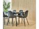 Dining area with sleek black table and chairs, complemented by wood slat wall at 1921 Fern Ave, Sarasota, FL 34235