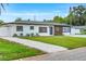Beautifully renovated single-story house with black trim, wood siding, and well-kept lawn at 1921 Fern Ave, Sarasota, FL 34235