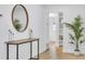 Bright entryway with stylish table and decor and a hallway leading to other rooms at 1921 Fern Ave, Sarasota, FL 34235