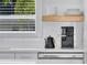 Modern white kitchen features stone countertops, floating shelves, and stainless steel appliances at 1921 Fern Ave, Sarasota, FL 34235