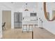 Bright and modern kitchen with sleek white cabinets, stainless steel appliances, and bar seating at 1921 Fern Ave, Sarasota, FL 34235