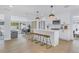 Open-concept kitchen featuring a large island, modern stainless steel appliances, and bar stool seating at 1921 Fern Ave, Sarasota, FL 34235