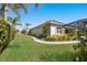 Well-manicured lawn and landscaping surrounds the home at 19798 Cobblestone Cir, Venice, FL 34292